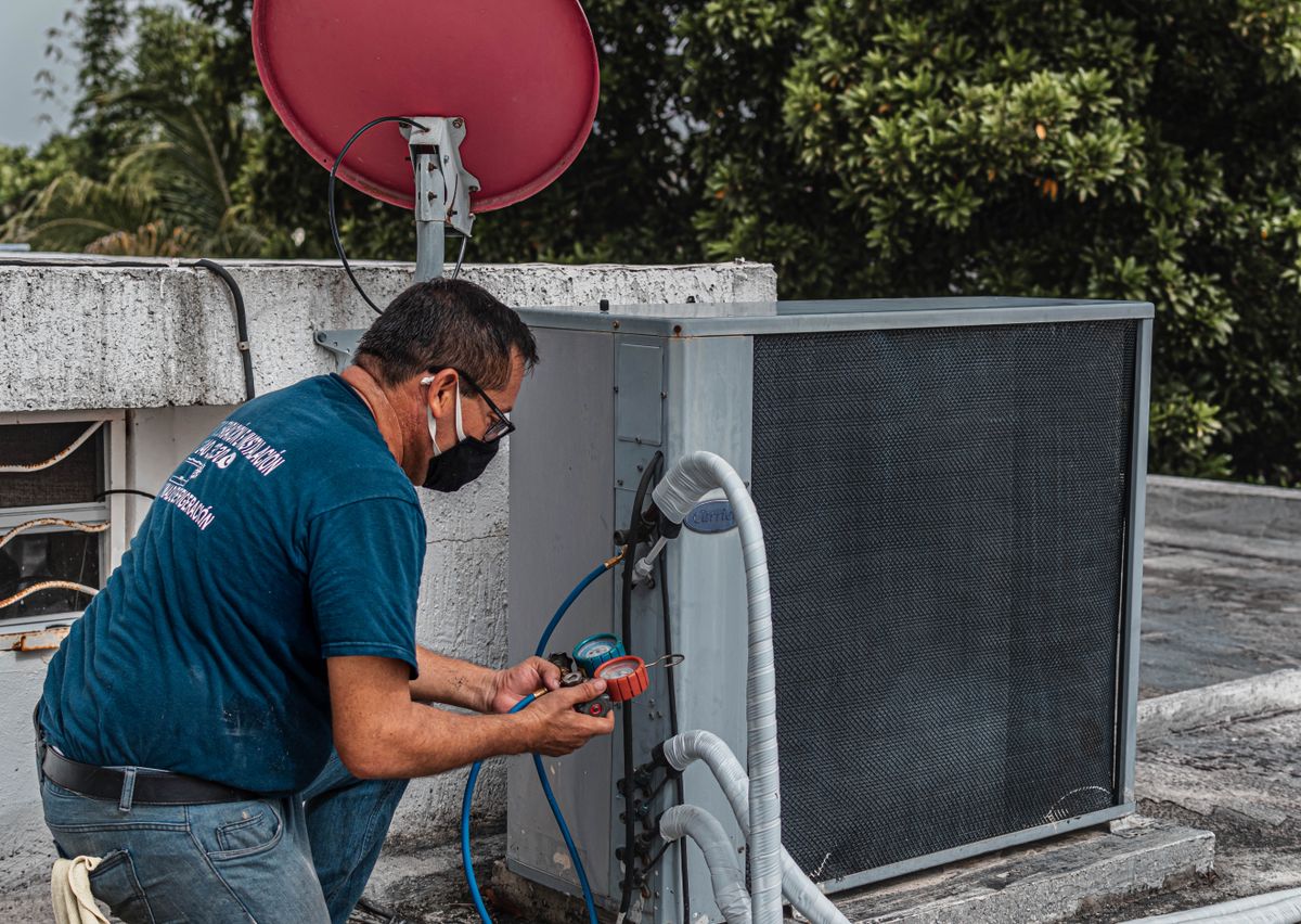 HVAC technician servicing a unit